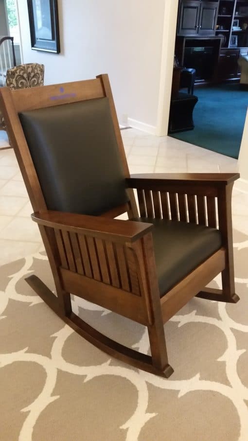 Black leather on brown rocking chair