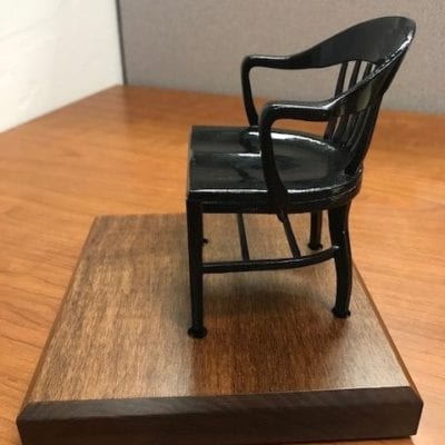 left side view black miniature college chair on brown maple base