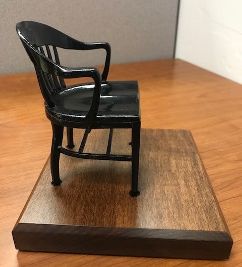 right side view black miniature college chair on brown maple base