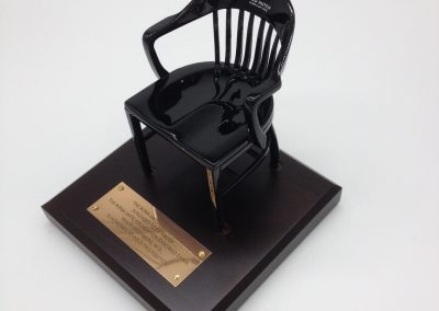 black miniature captain's chair of Fred Hutchinson CRCC on brown maple base with gold brass plat