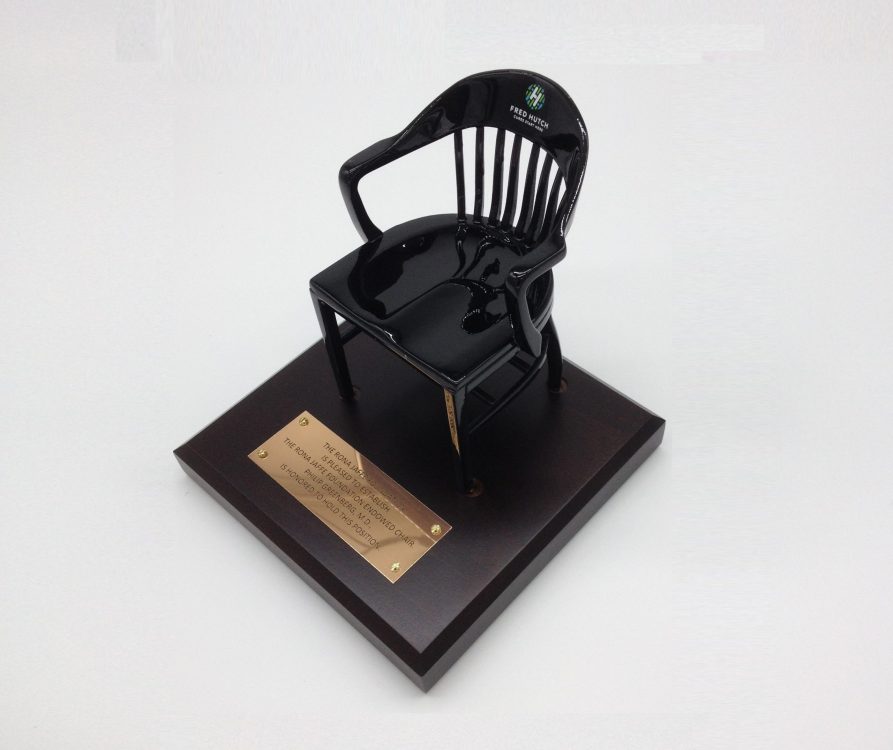 black classic alumni chair on brown base with barss plate