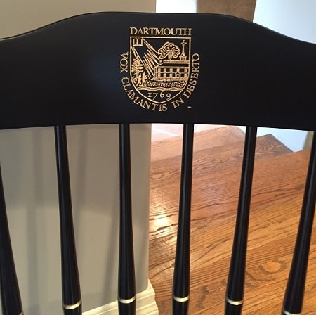 Top half of a black Dartmouth College Chair with gold crest; wooden college chair