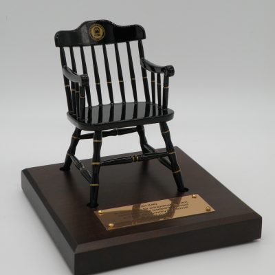 Black miniature captain's chair on brown maple base with brass nameplate - college chairs of Lajolla Country Day School