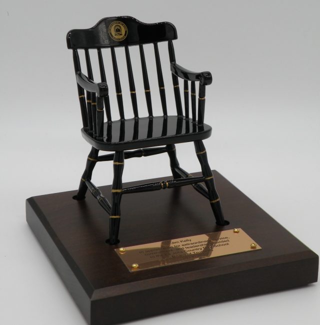 black miniature captain's chair of Carnegie Mellon University on brown maple base with gold brass plate
