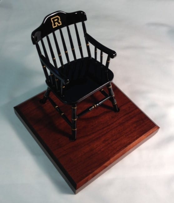 a black mininature chair on a brown maple base makes a fine gifts for board members
