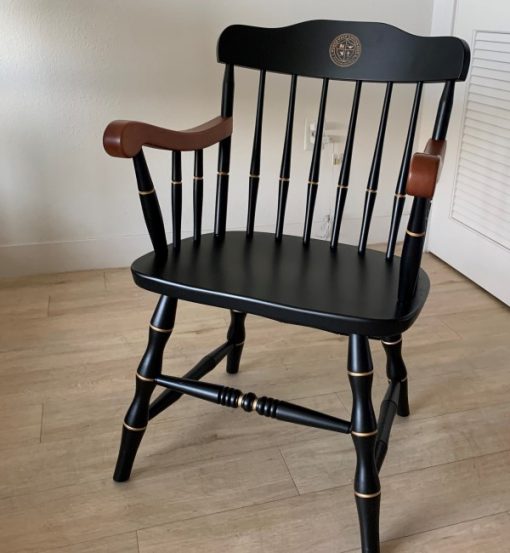 black Northwest University chair with gold seal and solid cherry arms for Client Testimonials