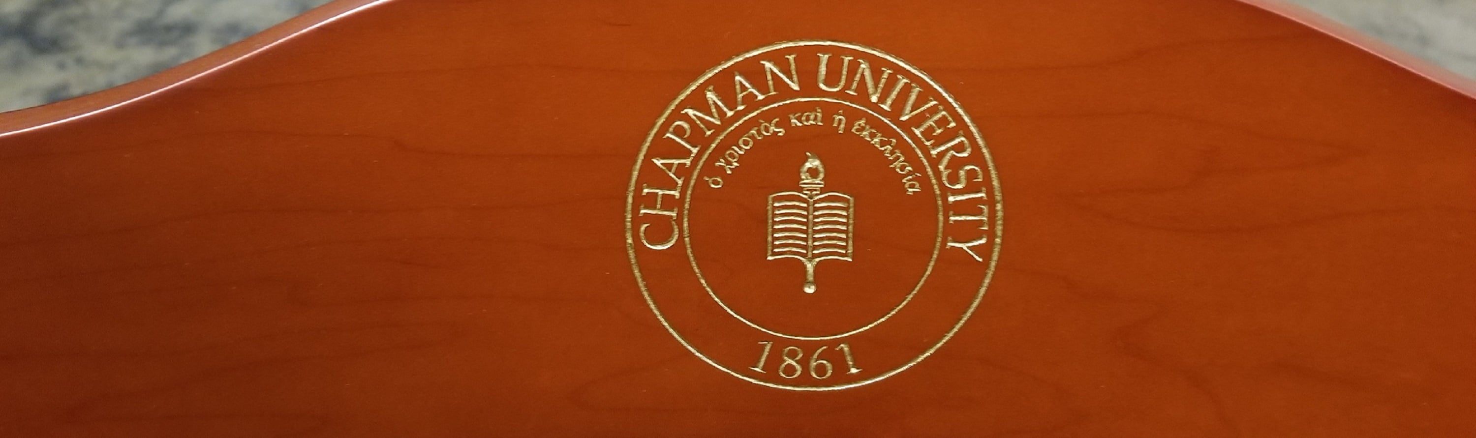 Chapman University Chair with gold Seal on the cherry crown; college chairs