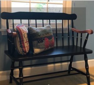 Black Deacon's Bench with cushions in front of window f client testimonials