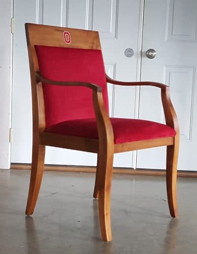 Side view of modern arm chair, the Laureate Chair, with Red Fabric upholstery