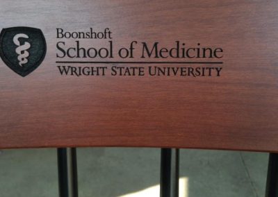 Black Boonshoft School of medicine chair with black engraved logo , example of college logos