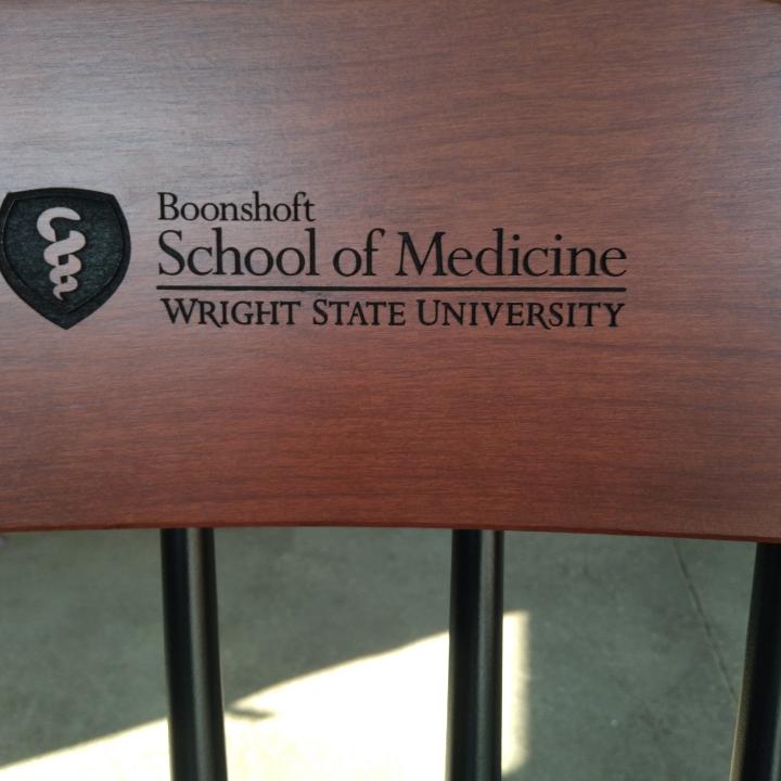 Black Boonshoft Medical School Chair with black logo engraved in the crown, wooden captains chair as gifts for medical students