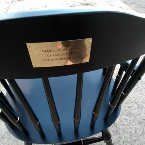 Personalized brass plate on rear of a black chair