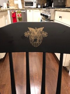 Gold USMA Logo on a black chair crown