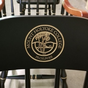 Black Mount Holyoke College chair with gold seal of college chairs