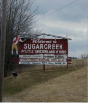 Road sign welcoming vistors to Sugarcreek, Ohio, a principal town in Amish country  for chairs made in the USA