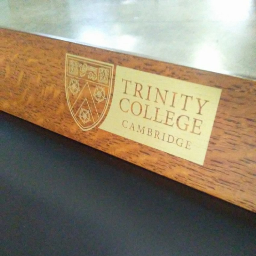 Trinity College shield anjd logo on light-brown, quarter-sawn oak logo chairs