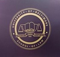 Gold Seal of University of Baltimore Law on black chair