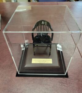 One black miniature chairs with acrylic cover